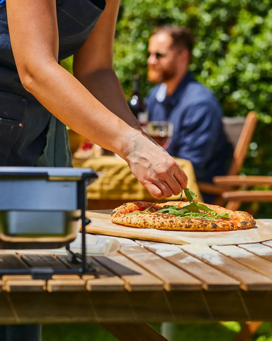 Zubereitung einer pizza salami bei einem Pizzaabend mit freunden