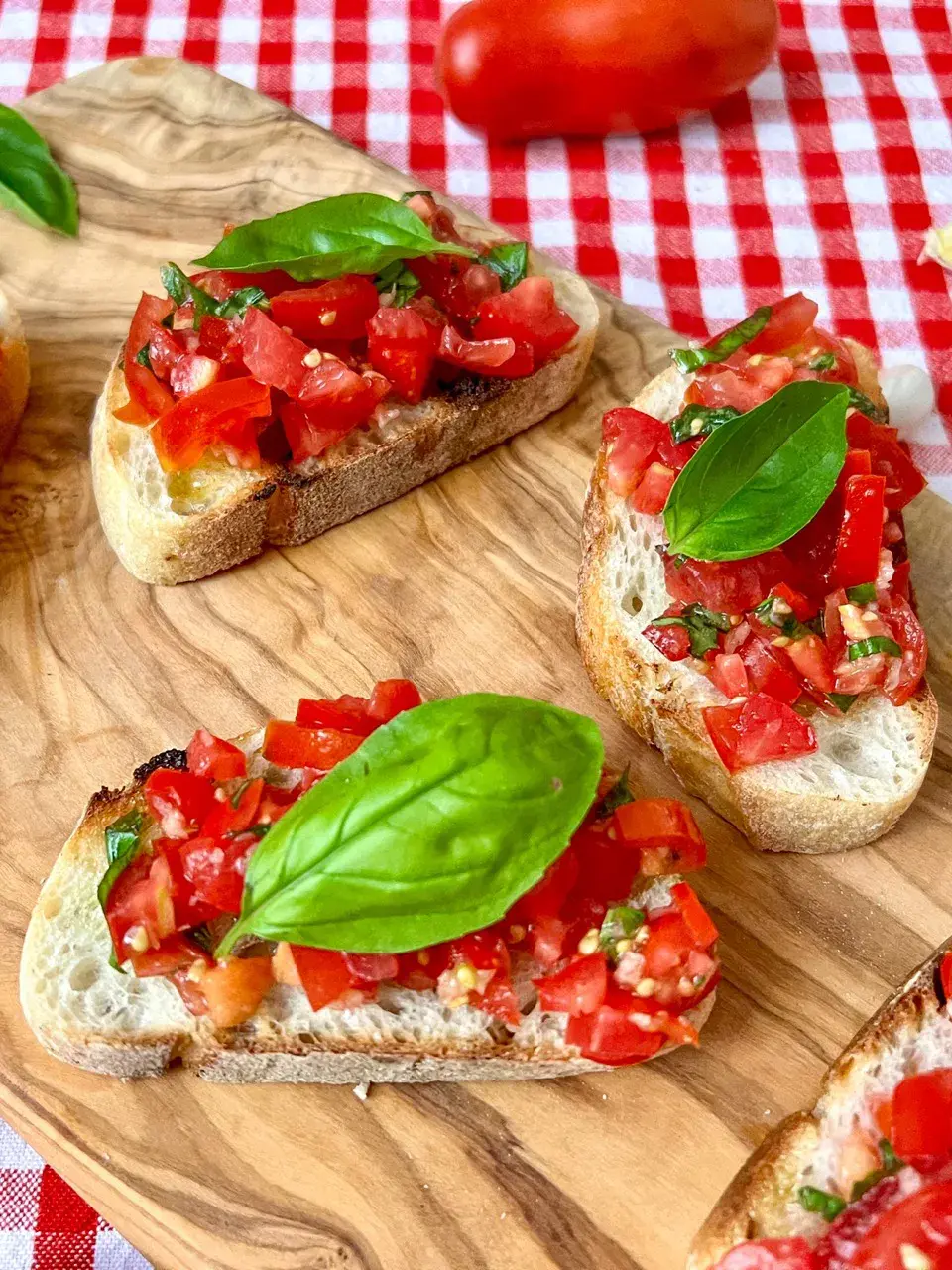 bruschetta mit basilikum auf einer holzplatte serviert
