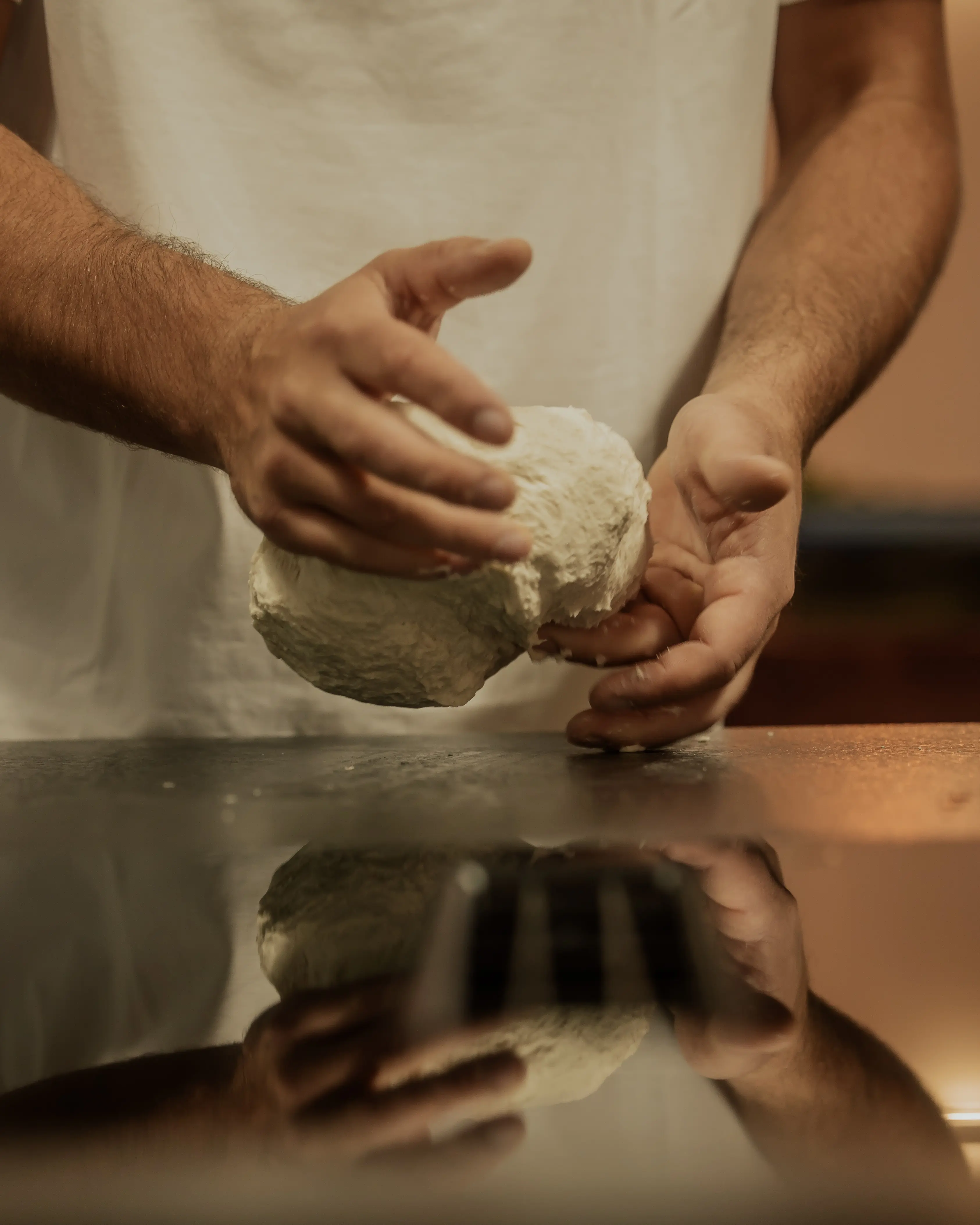Pizzateig von Hand kneten und die Teigkonsistenz prüfen